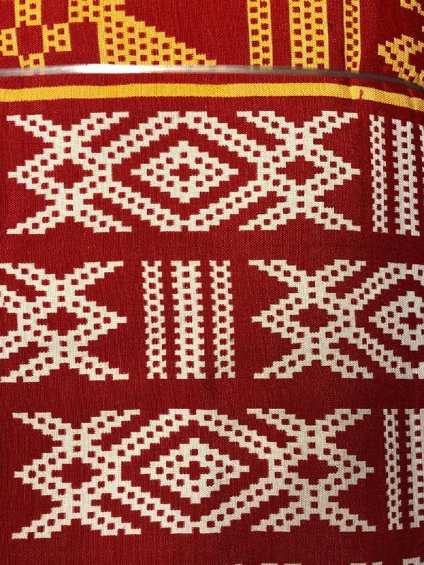100% Cotton woven kente print fabric in red with white and gold design pattern